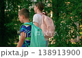 Happy children, boy girl, smiling, walking with backpacks to school. Children, brother sister, walking down street to school. Kids friends, together on street. Concept accessible children's education 138913900