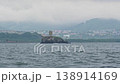 A lighthouse against a backdrop of gloomy skies and stormy weather on a cliff in Avacha Bay in the Pacific Ocean of the Kamchatka Peninsula 138914169