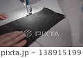 Tailor sewing fabric with sewing machine in close 138915199
