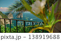 View of Faraglioni sea cliffs framed by palm leaves on summer day in Capri Italy 138919688