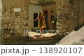 Woman tourist exploring quiet stone courtyard on a sunny summer day in Capri Italy 138920107