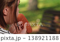 little girl having lunch with hamburger in nature setting, child with hamburger closeup portrait in summer light, adorable kid eating beef burger at outdoor restaurant, candid shot of little girl 138921188