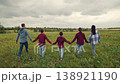 happy family, mother father children kid walking meadow holding hands, United family team walking in green meadow, happy parents and joyful kids, brother and sister playful time, outdoor excitement 138921190