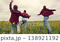 Happy family, kids running through green meadow nature, children game running, Kids in plaid on wild grass, Fun day in sunshine, Childhood energy outdoors, Team games in meadow, Natural beauty and joy 138921192