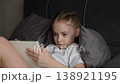 child playing tablet, little girl playing tablet, Calm moment of childhood with girl playing quietly on personal device indoors, Technology and childhood meet as girl explores her tablet screen with 138921195