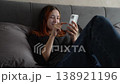 Woman talking phone, girl blogging online phone scrolling phone screen, screenshot of happiness, digital learning at home for young child in bed, emotional reaction, peaceful surroundings girl, happy 138921196