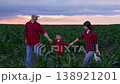 Sunset Farm, Beautiful sky colors, Day ending slowly, Family time together, Cornfield at dusk, Shining green plants, Parents and child, Walking in harmony, Soft light glow, Horizon stretches far, Farm 138921201