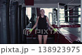 A female boxer trains intensely with a jump rope, improving her footwork, speed, and cardiovascular endurance as she prepares for the demands of the boxing ring. 138923975