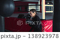 The young female boxer hones her striking skills during a punching bag workout, mixing speed, power, and control to prepare for upcoming matches. Slow motion 4k footage. 138923978