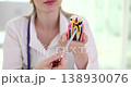 Hands of dentist with tooth with caries in dental clinic 138930076