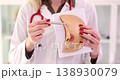 Female doctor explains disease and using anatomical model of breast 138930079