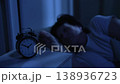 Elderly woman with insomnia tossing and turning looking at clock 138936723