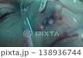 Woman with oxygen mask waking up after coma or surgery 138936744
