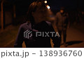 Woman running from robber on dark city street at night  138936760