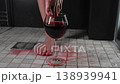 Foot fetish. A woman dips her toes in a glass of red wine. 138939941