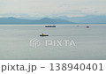Tankers and ships sail in the ocean bay against the backdrop of Kamchatka's picturesque mountains and volcanoes. Fishing industry 138940401
