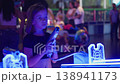 Girl playing laser tag shooting game in neon lit 138941173