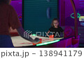 Girl playing air hockey game with friend in 138941179