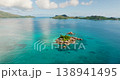 A small island surrounded by clear turquoise water with lush vegetation and rocks. St Pierre Island, Seychelles. 138941495