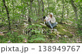 Canistherapy lesson. Training Social and medical rehabilitation. A man with a border collie dog sits in the forest 138949767