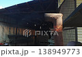Smoke escapes from the iron pipe of a forklift against the background of a warehouse 138949773