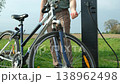 Close up of cyclist using public bike repair station in the countryside 138962498
