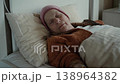 Elderly woman with IV drip lying in bed at home receiving care 138964382