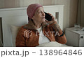 Woman in headscarf with cancer talking on phone with optimism or acceptance 138964846