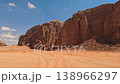 Aerial view of red sand tracks and massive sandstone rock formations under a blue sky in Wadi Rum 138966297