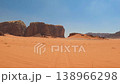 Aerial view of red sand dunes and sandstone rock formations under a clear sky within the desert of 138966298