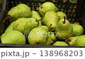 The farmer's hands put ripe pears just picked from the tree into a box. 138968203