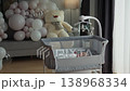 Newborn baby rests peacefully in crib with balloons and teddy bear. Cozy nursery decor baby shower celebration family joy parenthood infant child mother parenting lifestyle home adorable moment 138968334