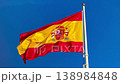 Spanish Flag Waving on Flagpole Against Clear Blue Sky, National Symbol of Spain, 4k 138984848