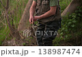 Close up tilt up camera shot of fisherman casting fishing rod with spinning reel. Outdoor angling 138987474
