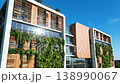 Modern sustainable multi-story building with vertical living green walls and wooden facade 138990067