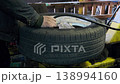 Mechanic Working on Car Tire 138994160