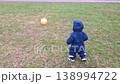 Toddler walking on grass towards a ball 138994722