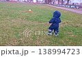Toddler in jumpsuit taking first steps on grass 138994723