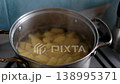 Boiling potatoes pot glass lid steam opening closing lid home cooking stove blue tiles kitchen 138995371
