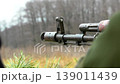 the muzzle of a machine gun aiming from a dugout and waiting for a target, 139011439