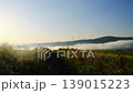 Mist flow covers mountain bottom windmills work under blue sky 139015223