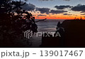Sunset ocean cliffside view over dark dramatic water and clouds at dusk, serene natural landscape 139017467