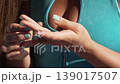Female, rings, hands, woman adjusts trendy silver jewelry on her fingers, fashion accessories close up 139017507