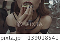 Woman eating a sandwich with black caviar. 139018541