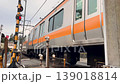 A train on the Ome Line passing through a level crossing in Ome City, Tokyo. 139018814