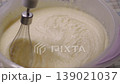 Close-up of kitchen mixer whipping buttercream in plastic bowl 139021037