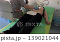Patient doctor ultrasound abdomen clinic medical examination healthcare procedure diagnostic scan in pediatric room. Clinician uses probe on belly during abdominal checkup on exam table. 139021044
