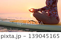 Happy young woman walking on stand up paddle sup board by the sea during summer vacation. Beautiful girl flat water paddling against sea and sky background. Healthy lifestyle concept. Slow motion 139045165