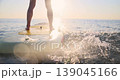 Happy young woman walking on stand up paddle sup board by the sea during summer vacation. Beautiful girl flat water paddling against sea and sky background. Healthy lifestyle concept. Slow motion 139045166