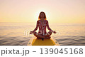 Happy young woman walking on stand up paddle sup board by the sea during summer vacation. Beautiful girl flat water paddling against sea and sky background. Healthy lifestyle concept. Slow motion 139045168